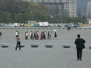 Travrel guide crosses the Imperial Palace Plaza